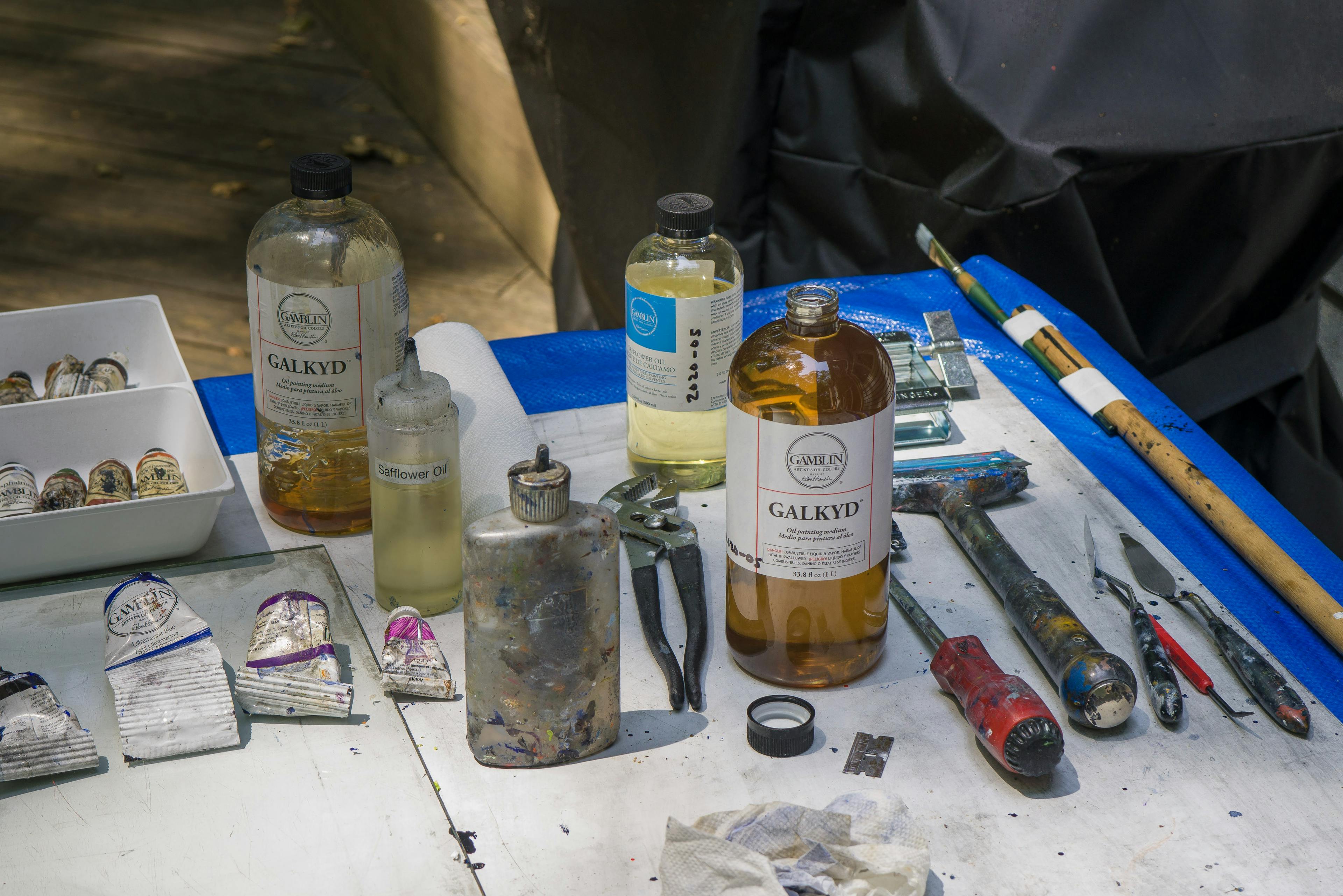 Christopher's painting tools on a glass palette outside
